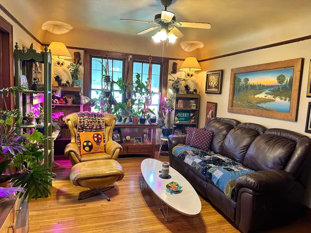 a living room with furniture and a floor to ceiling window