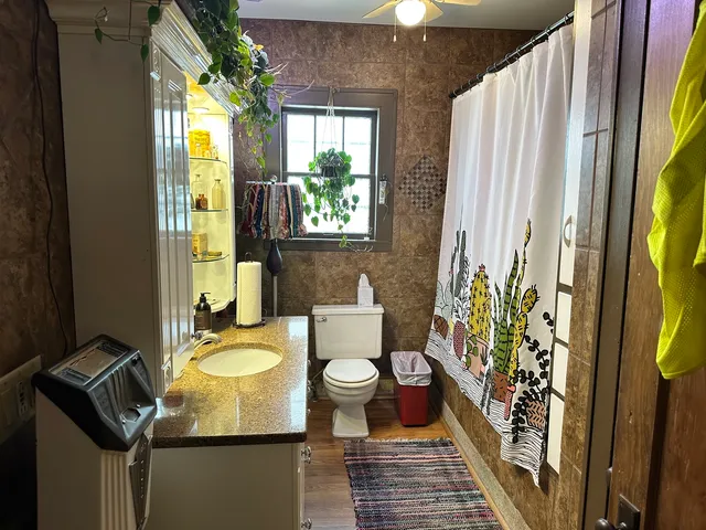 a bathroom with a sink toilet and shower