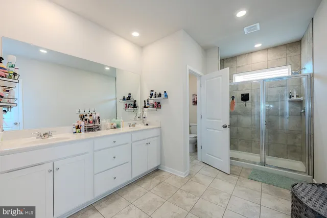 a view of a hallway to closet and a bathroom