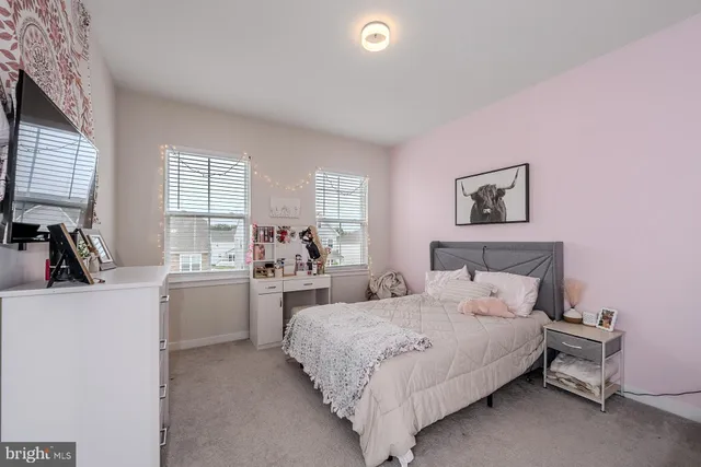 a bedroom with a bed and a view of bedroom