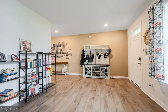 a view of a room with lots of wooden furniture and entryway