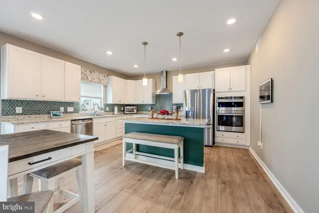 a kitchen with stainless steel appliances granite countertop a refrigerator sink and cabinets