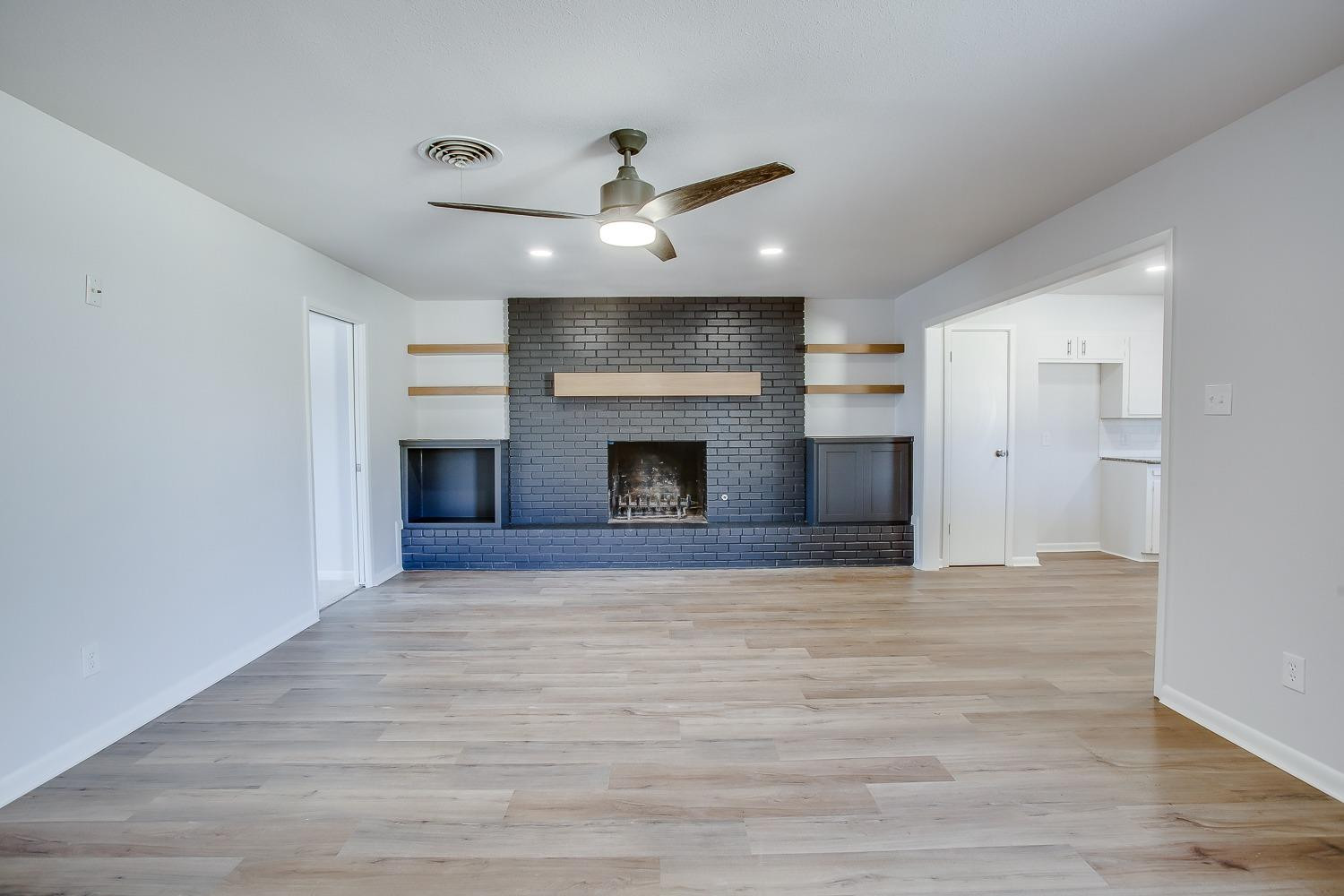 3410 53rd Street Lubbock, TX 79413 - Photo 2 of 14 an empty room with windows and fireplace