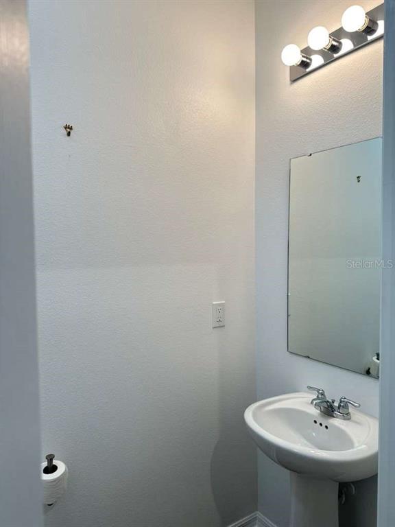 9031 Legado Drive Windermere, FL 34786 - Photo 22 of 27 a bathroom with a sink toilet and mirror