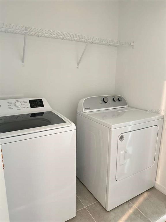 9031 Legado Drive Windermere, FL 34786 - Photo 24 of 27 a utility room with dryer and washer