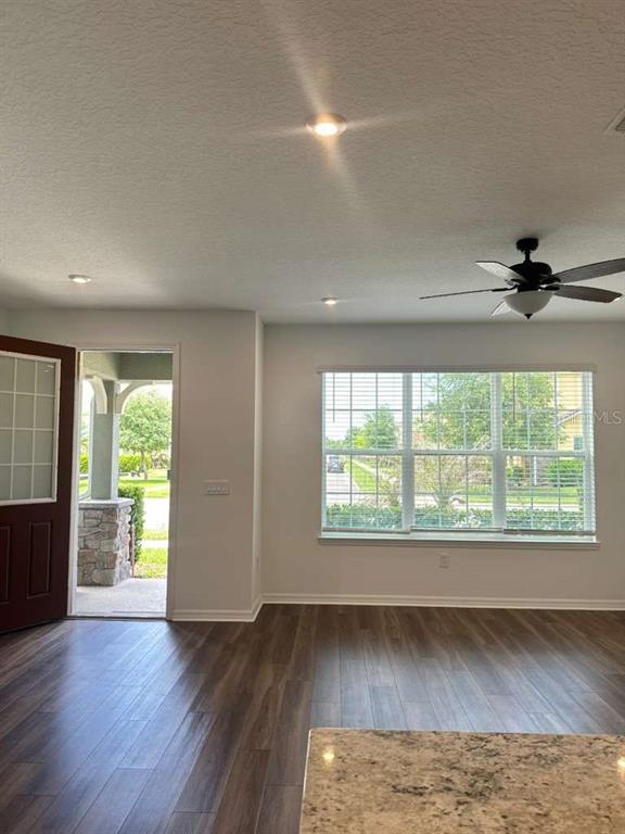 9031 Legado Drive Windermere, FL 34786 - Photo 4 of 27 a view of an empty room with wooden floor and a window