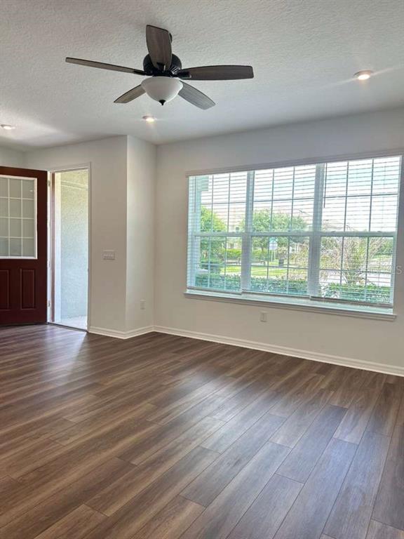 9031 Legado Drive Windermere, FL 34786 - Photo 5 of 27 a view of an empty room with wooden floor and a window