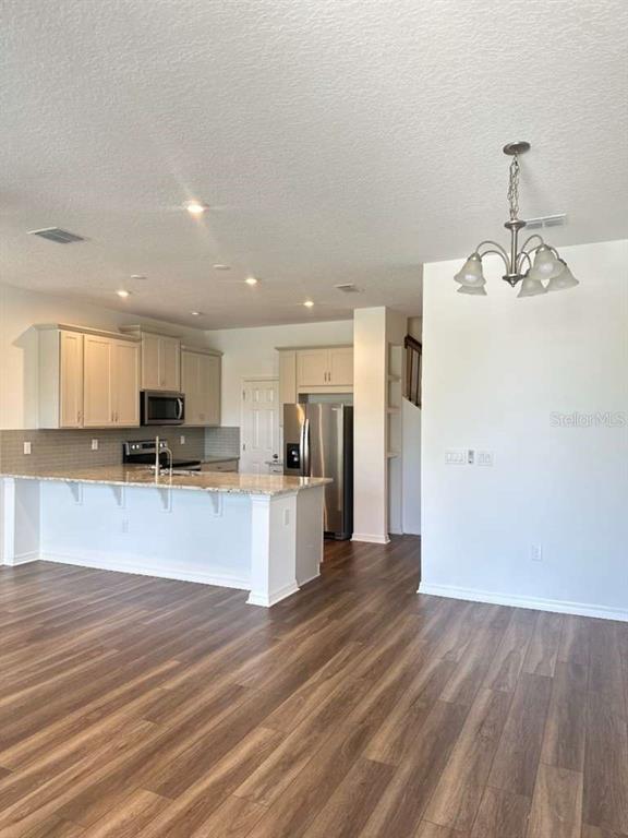 9031 Legado Drive Windermere, FL 34786 - Photo 7 of 27 a view of kitchen with refrigerator stove and wooden floor