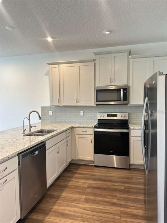 9031 Legado Drive Windermere, FL 34786 - Photo 10 of 27 a kitchen with a sink appliances and cabinets