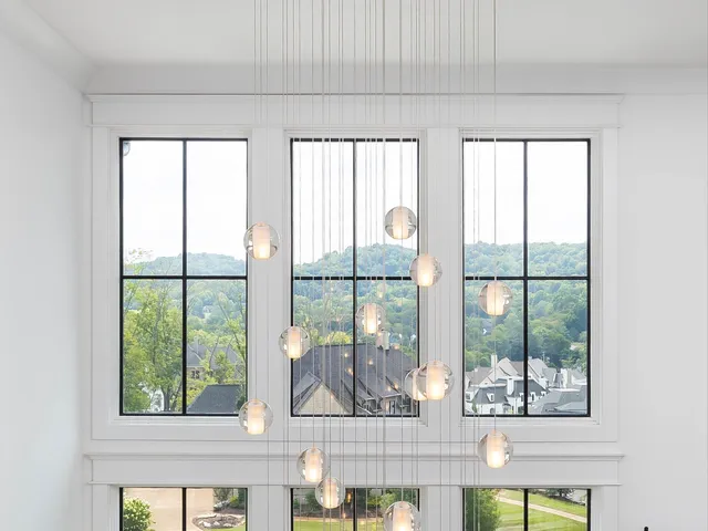 a kitchen with stainless steel appliances granite countertop a sink a stove and a wooden floors