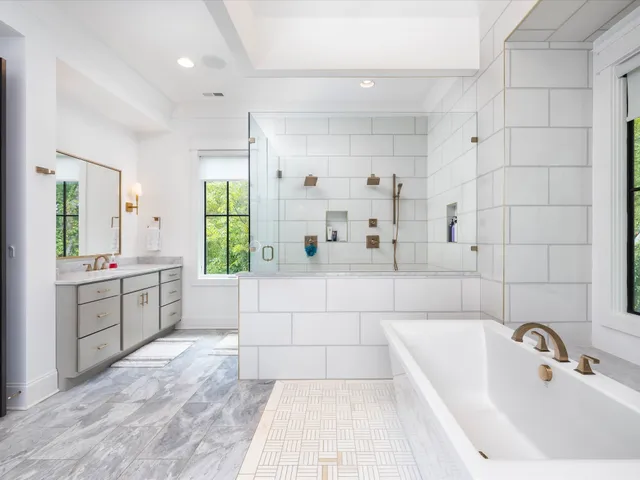 a view of an empty room with window and hardwood floor