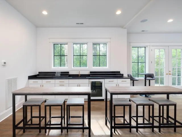 a view of a swimming pool with outdoor seating and plants