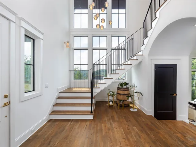 a view of entryway and hall with wooden floor