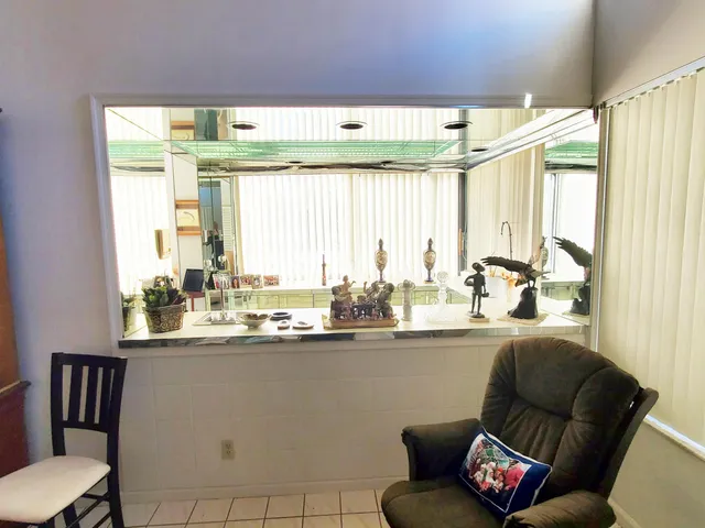 a dining room with furniture window and a chandelier