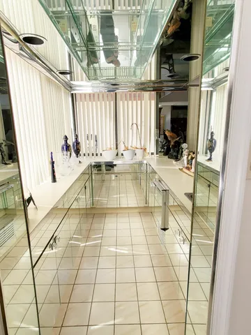 a large white kitchen with a sink and cabinets