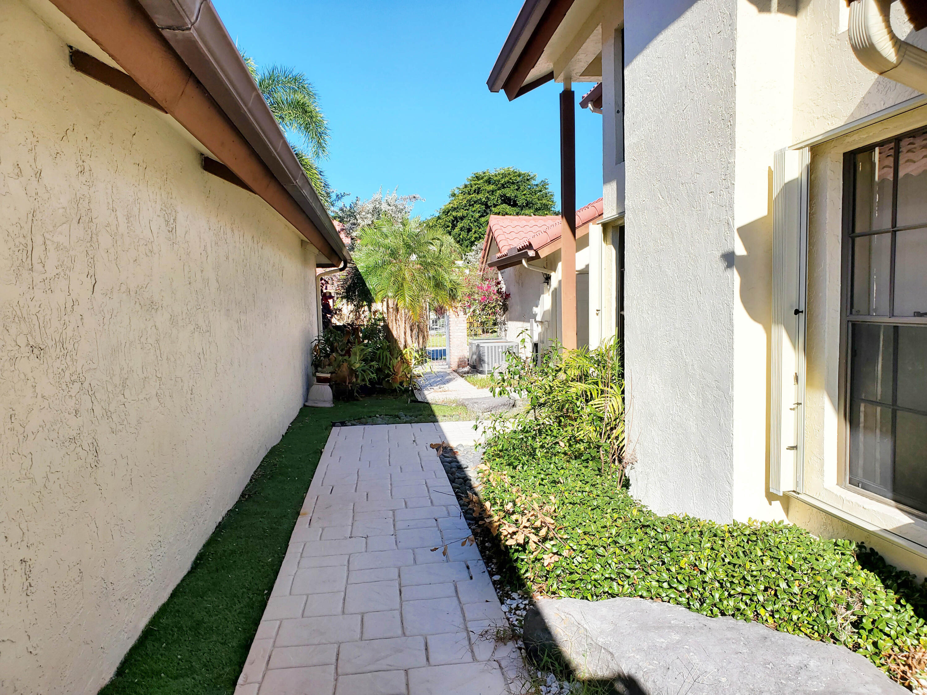 21742 Club Villa Terrace Boca Raton, FL 33433 - Photo 34 of 38 a view of a pathway both side of a house