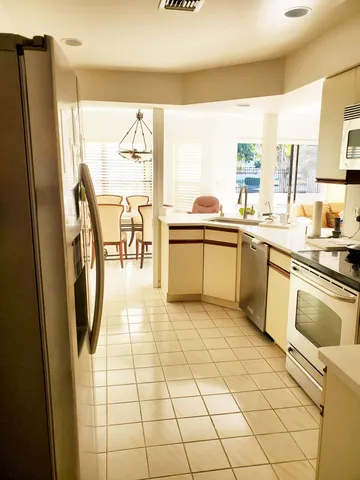 a kitchen with stainless steel appliances a stove a sink and a refrigerator