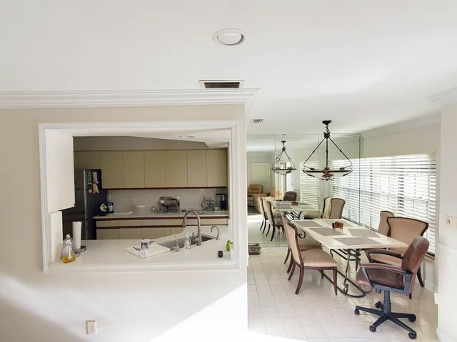 a dining hall with granite countertop a sink and a stove