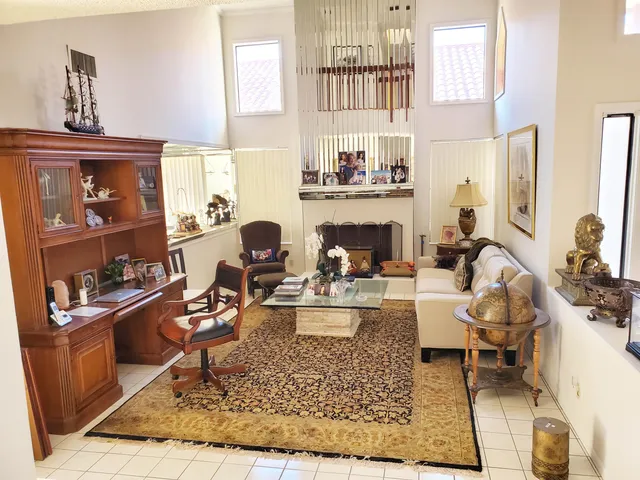a living room with furniture a rug and a fireplace