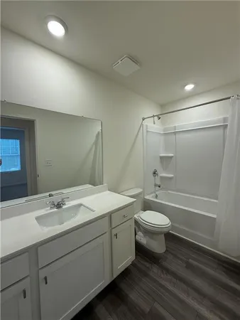 a bathroom with a double vanity sink toilet and shower