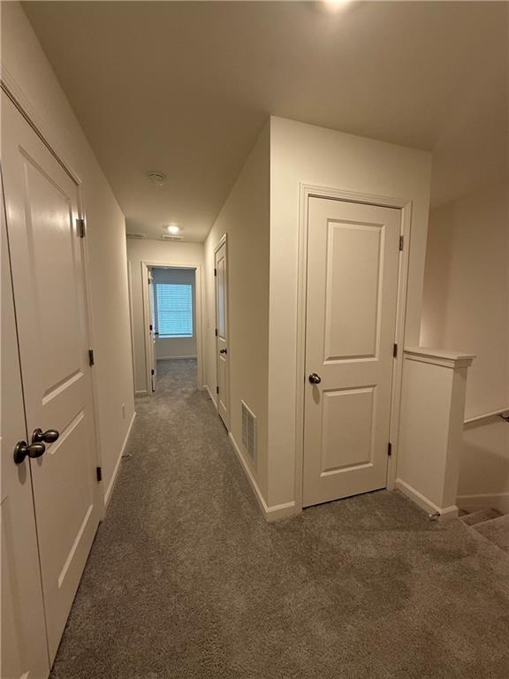 306 Rydal Way Winder, GA 30680 - Photo 15 of 19 a view of a hallway with closet and wooden floor