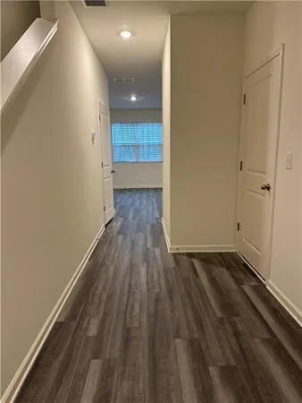 a view of a room with wooden floor