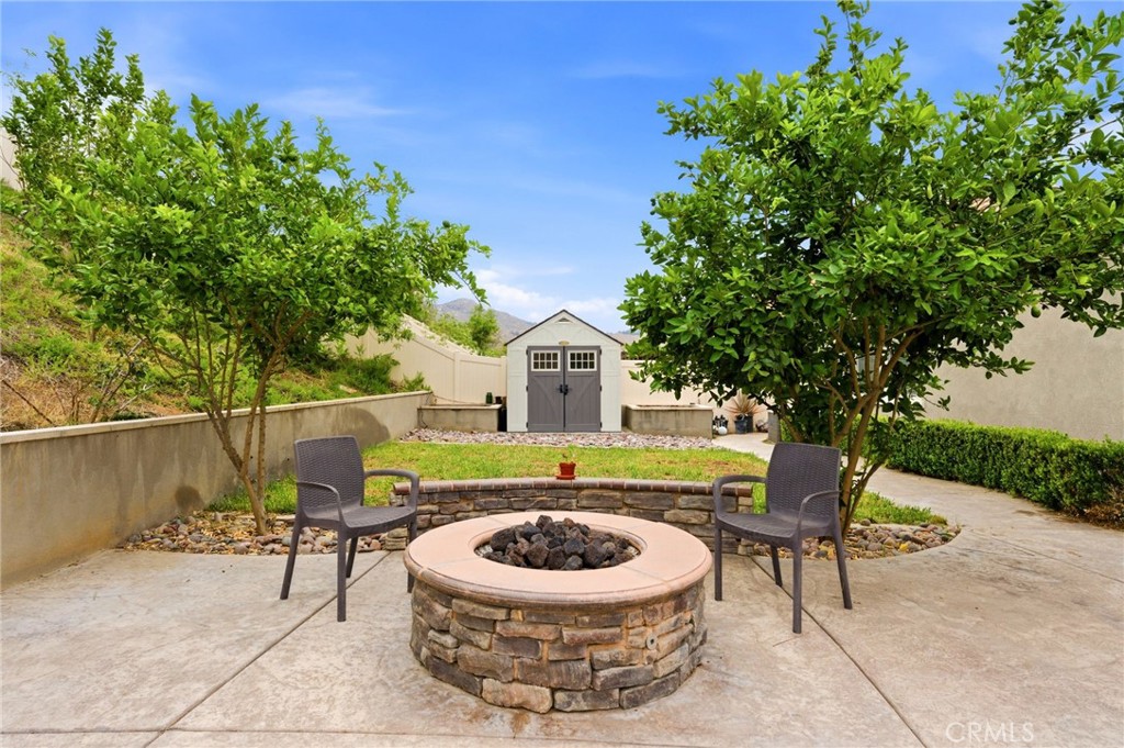 20948 Center Street Riverside, CA 92507 - Photo 74 of 92 a view of a chairs and table in the back yard of the house