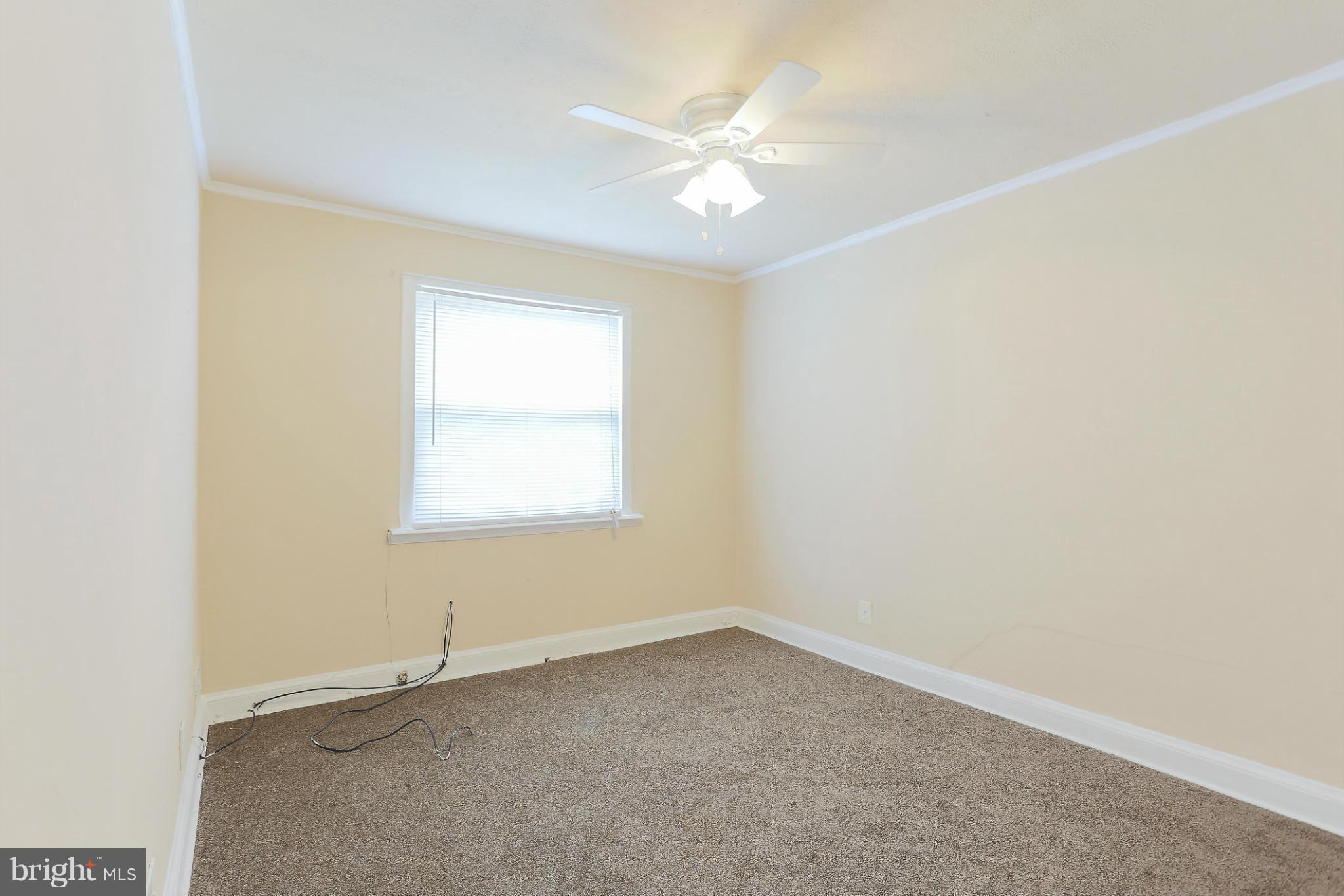 845 Benninghaus Road Baltimore, MD 21212 - Photo 15 of 19 an empty room with a window and a ceiling fan