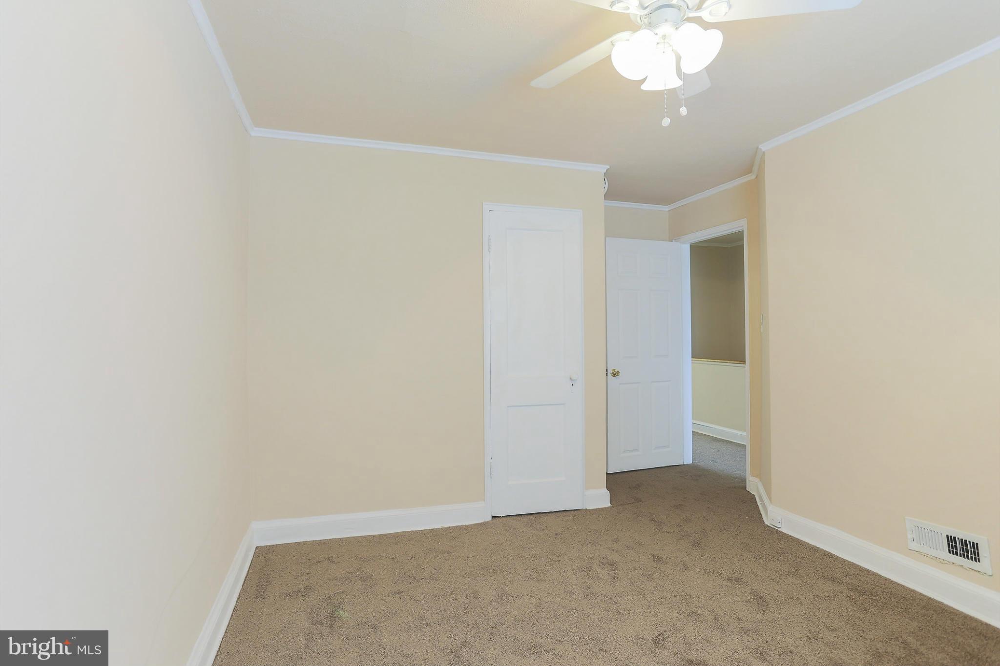 845 Benninghaus Road Baltimore, MD 21212 - Photo 16 of 19 an empty room with a chandelier fan and glass door