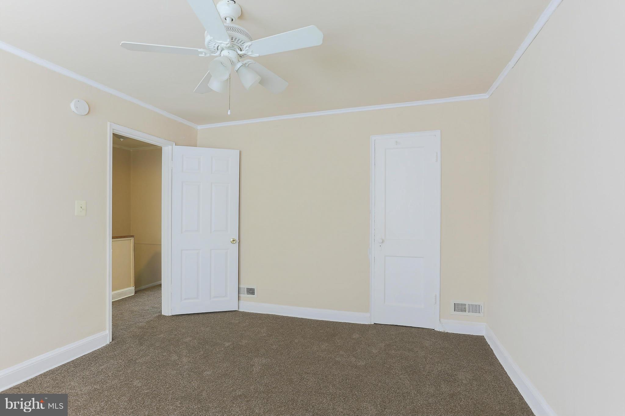 845 Benninghaus Road Baltimore, MD 21212 - Photo 18 of 19 an empty room with a ceiling fan and a window