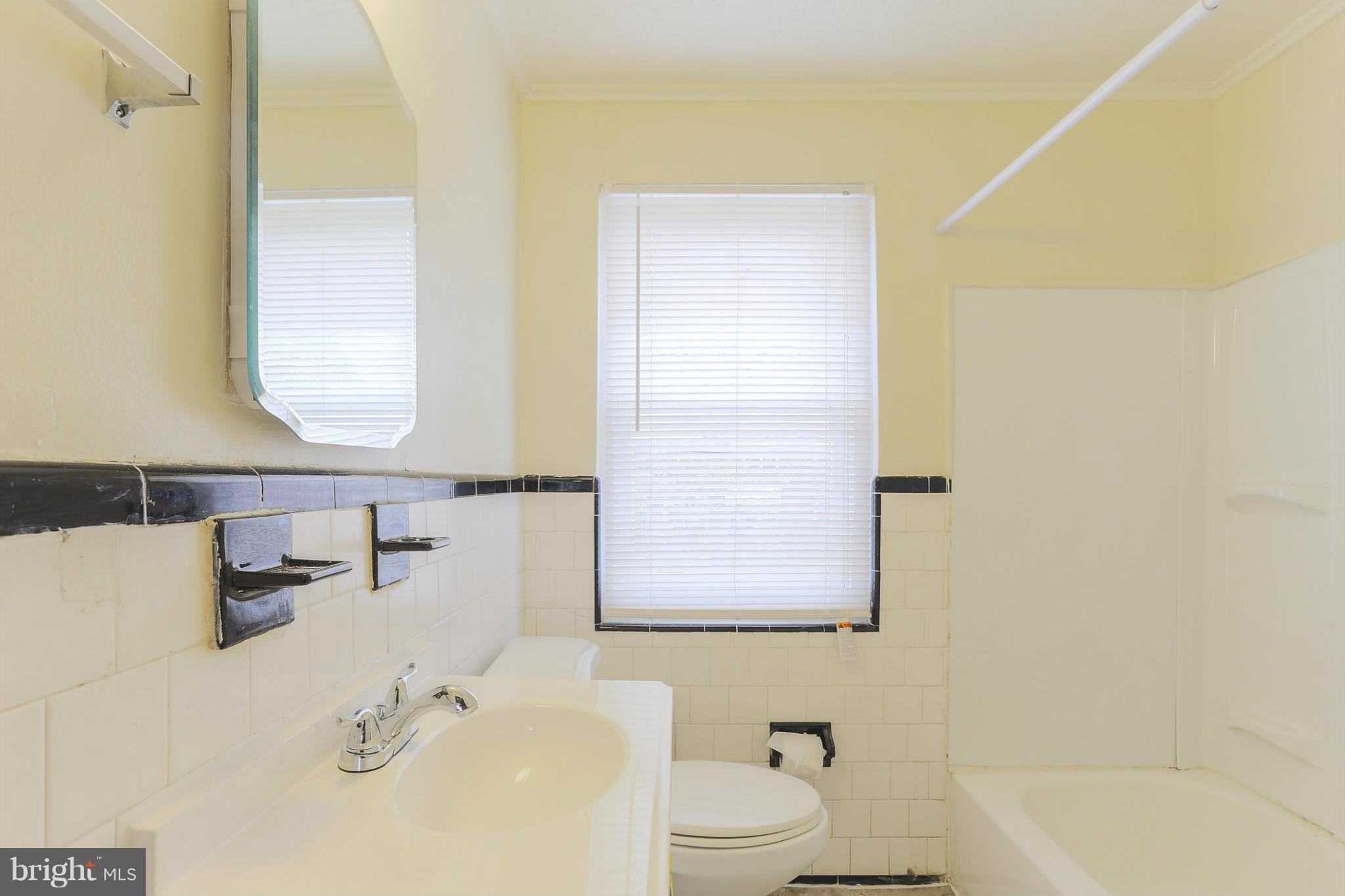 845 Benninghaus Road Baltimore, MD 21212 - Photo 19 of 19 a bathroom with a sink and a mirror