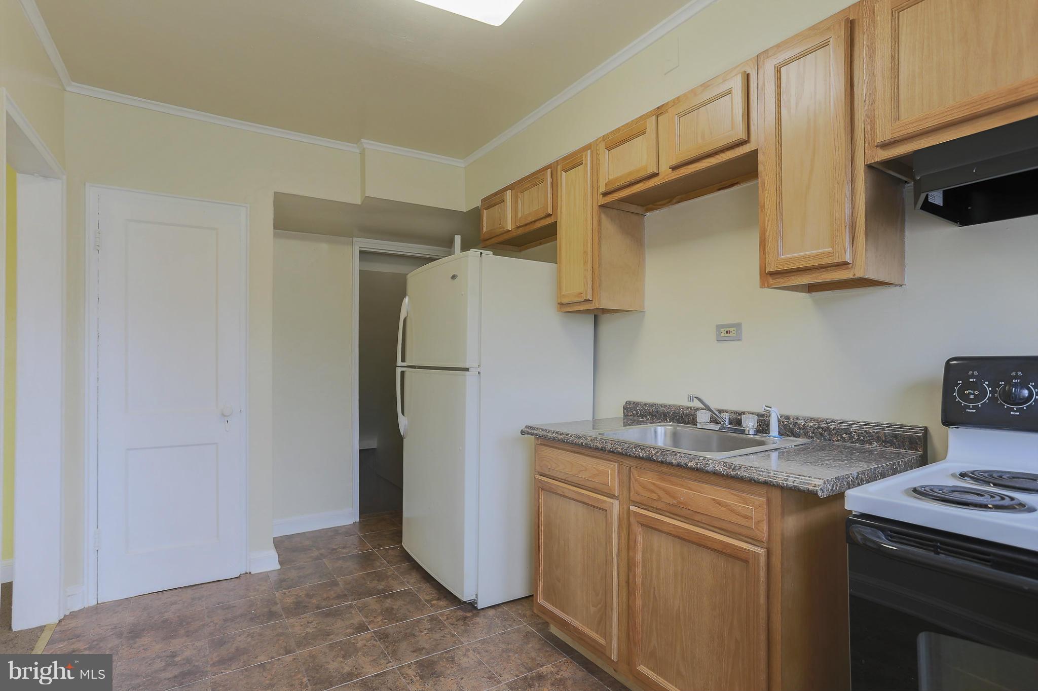 845 Benninghaus Road Baltimore, MD 21212 - Photo 10 of 19 a kitchen with stainless steel appliances granite countertop a sink stove and refrigerator