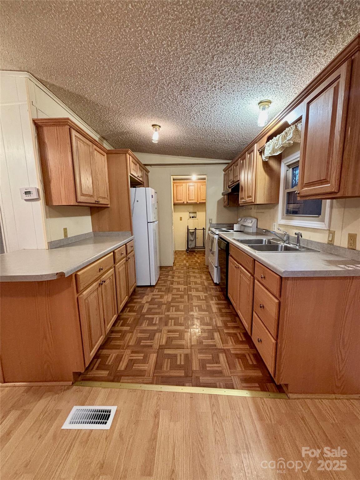 298 West B Phindeck Road Bostic, NC 28018 - Photo 11 of 34 a large kitchen with stainless steel appliances granite countertop a stove a sink dishwasher and cabinets with wooden floor