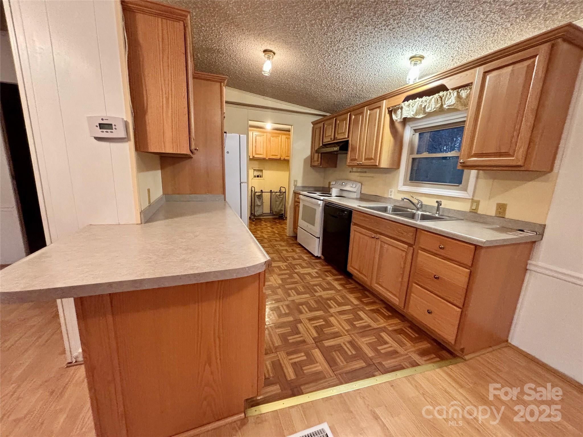 298 West B Phindeck Road Bostic, NC 28018 - Photo 15 of 34 a kitchen with stainless steel appliances a stove refrigerator sink and microwave