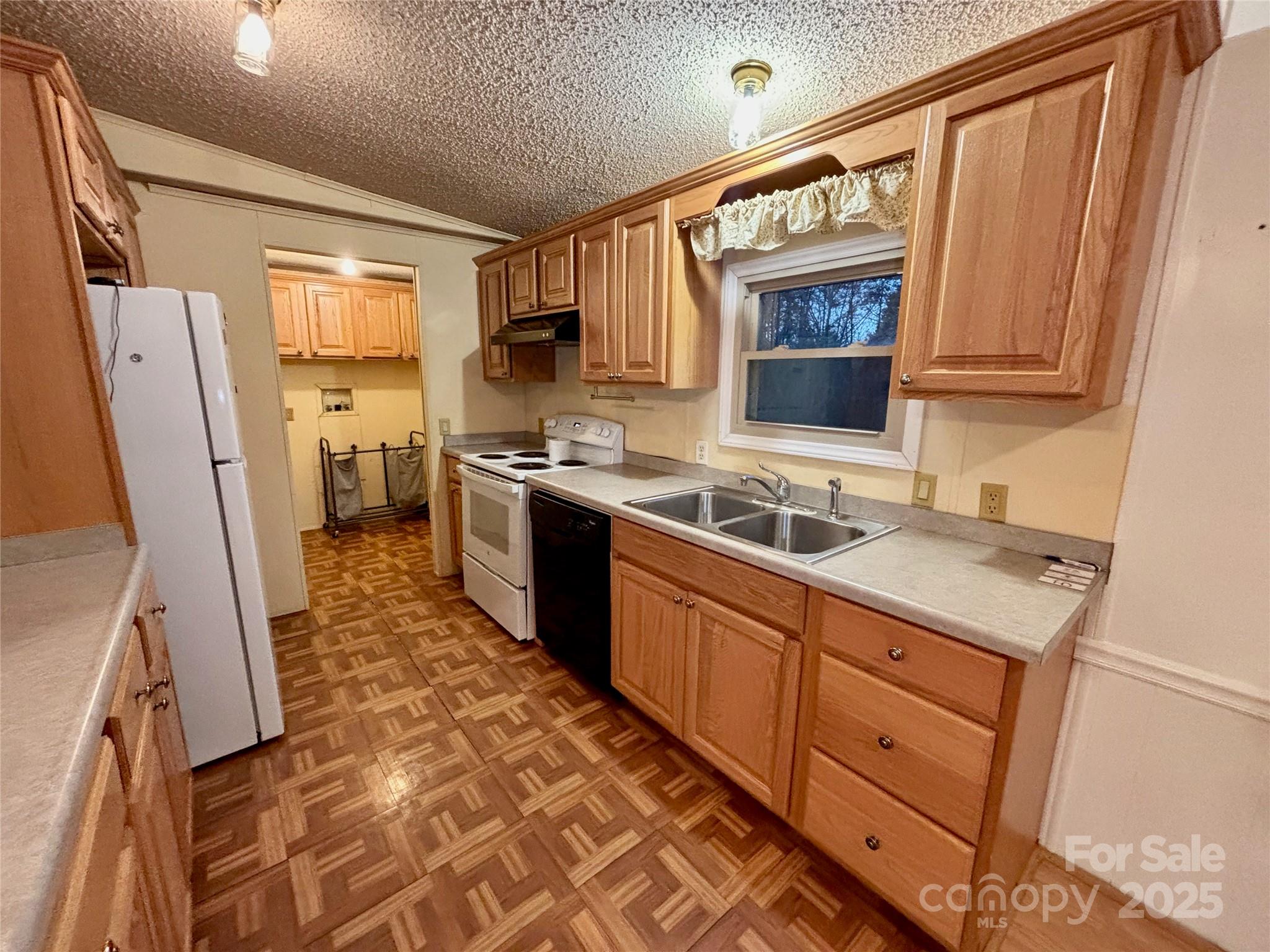 298 West B Phindeck Road Bostic, NC 28018 - Photo 16 of 34 a kitchen with wooden cabinets and a sink