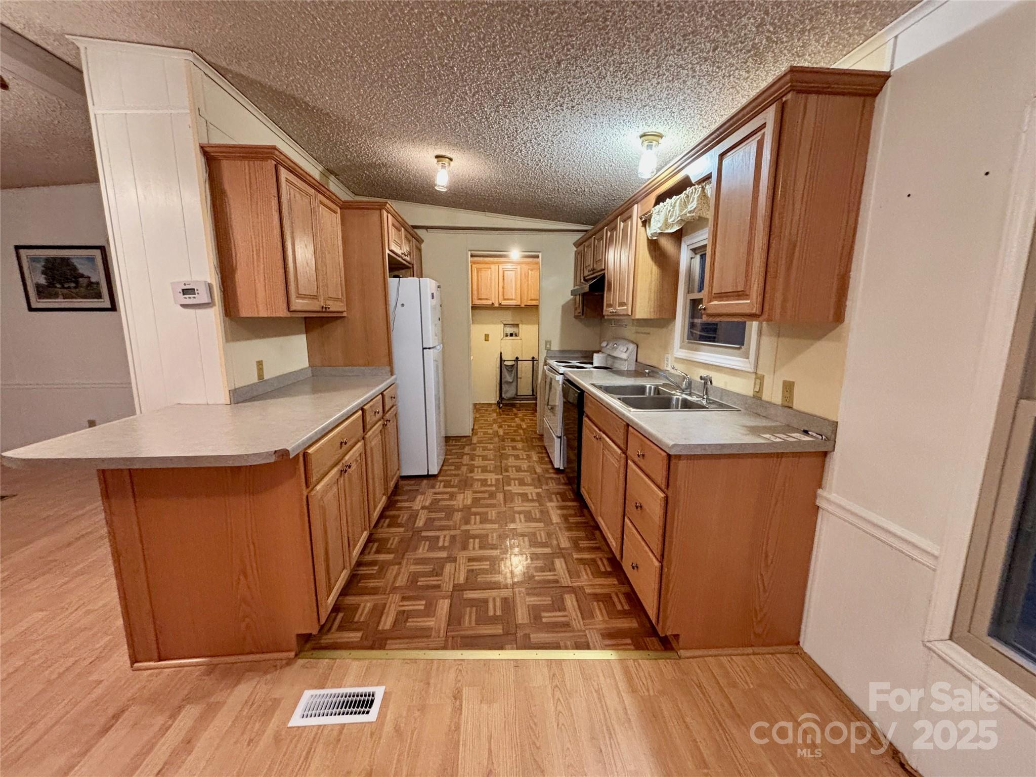 298 West B Phindeck Road Bostic, NC 28018 - Photo 17 of 34 a kitchen with stainless steel appliances granite countertop a stove a sink dishwasher and a refrigerator