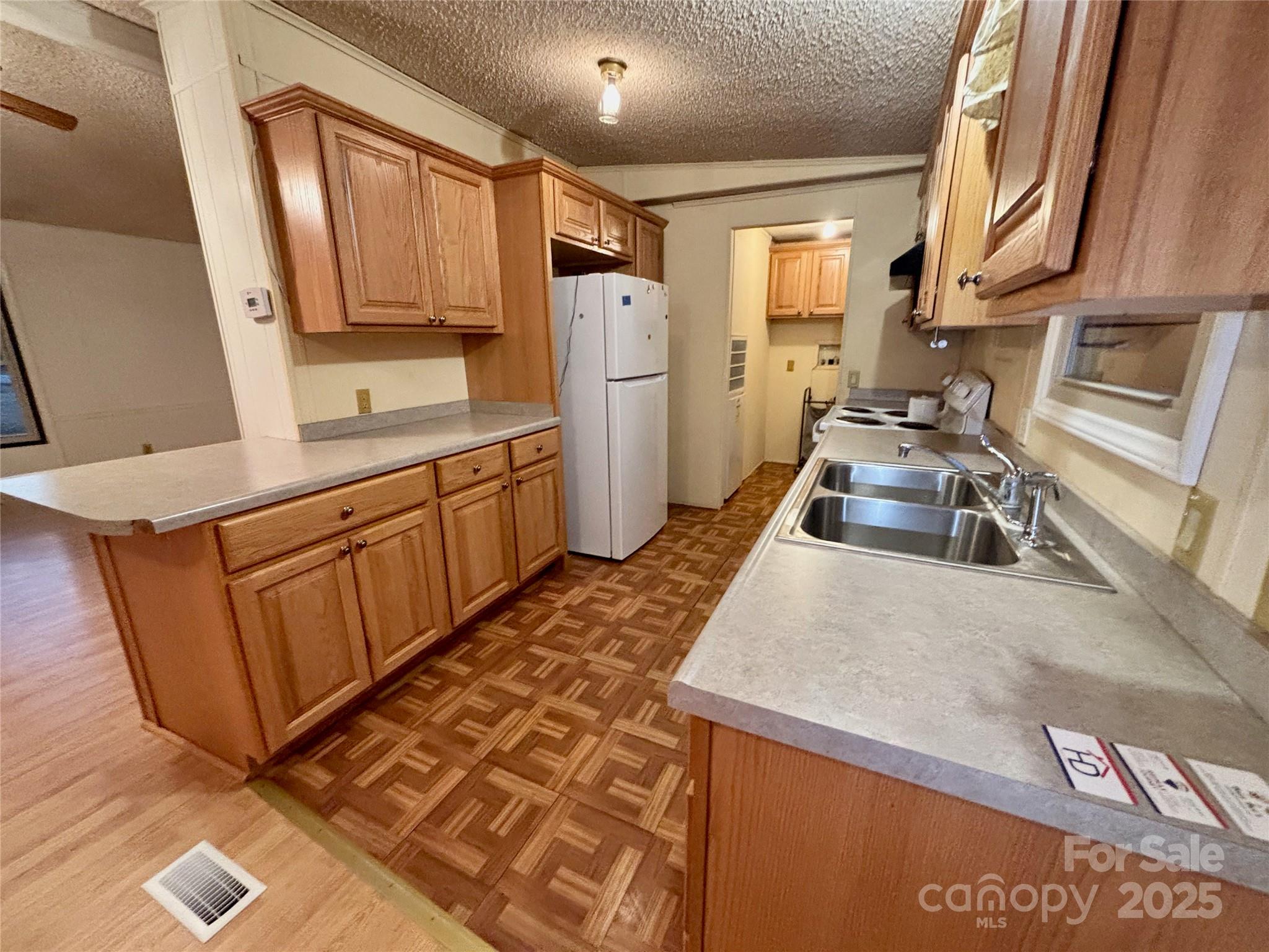 298 West B Phindeck Road Bostic, NC 28018 - Photo 22 of 34 a kitchen with wooden cabinets and a sink