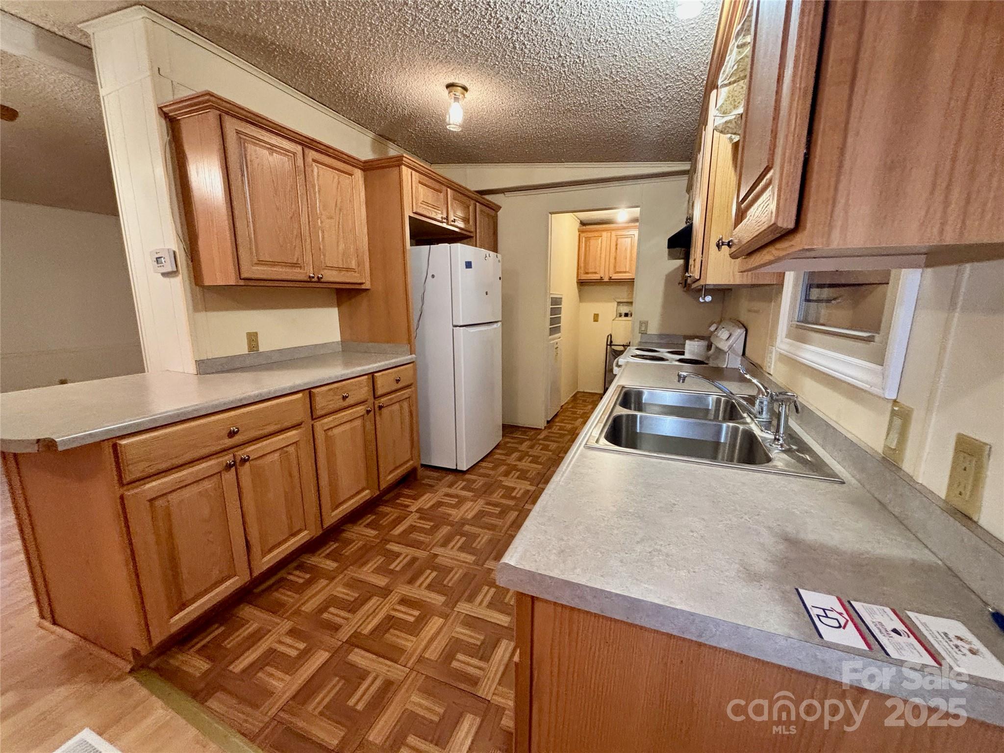 298 West B Phindeck Road Bostic, NC 28018 - Photo 23 of 34 a kitchen with stainless steel appliances granite countertop a sink stove and refrigerator