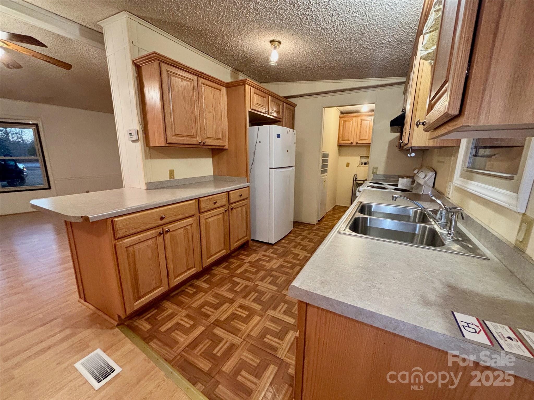 298 West B Phindeck Road Bostic, NC 28018 - Photo 24 of 34 a kitchen with granite countertop a sink stove and refrigerator