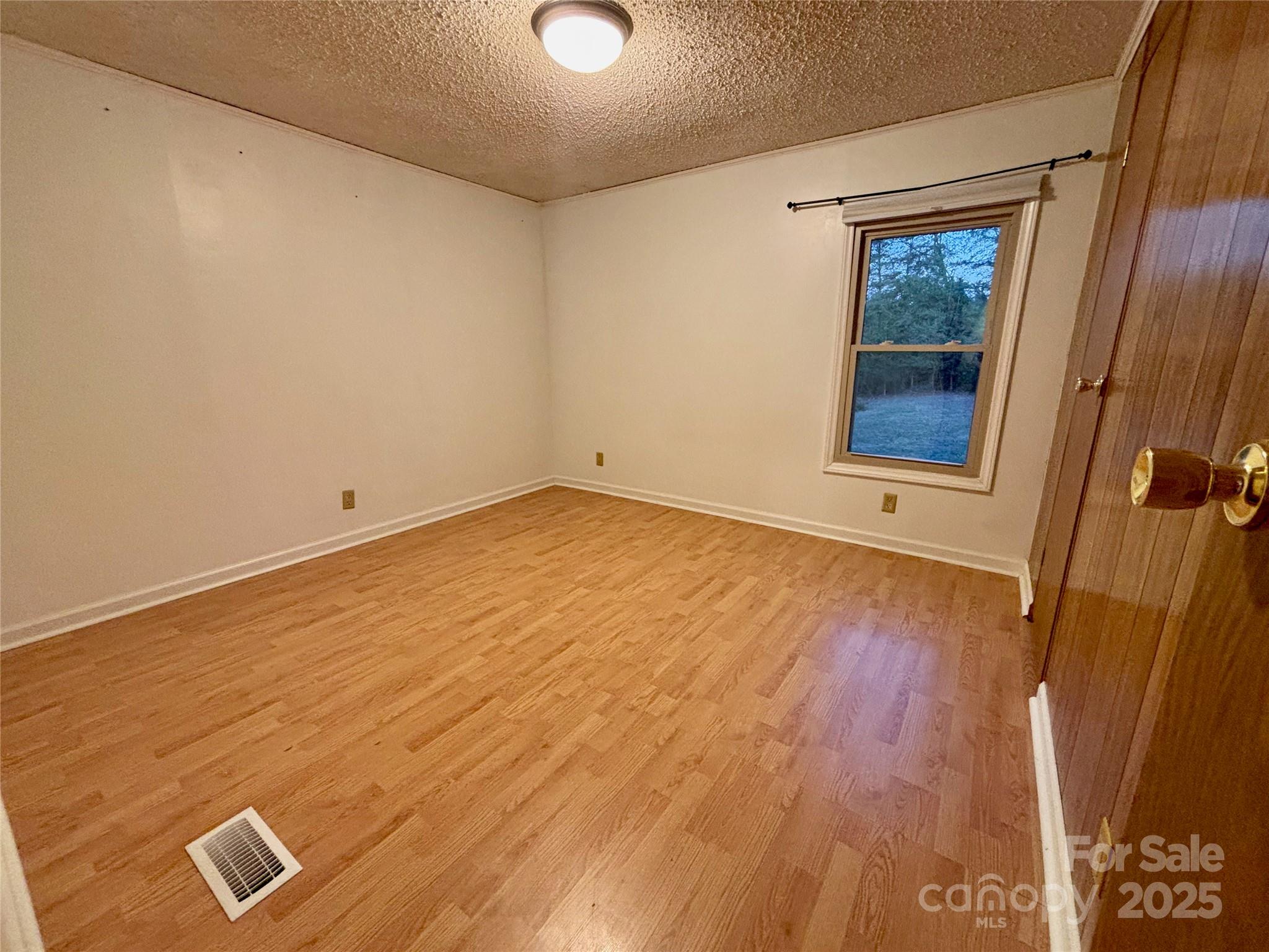 298 West B Phindeck Road Bostic, NC 28018 - Photo 26 of 34 an empty room with wooden floor and windows