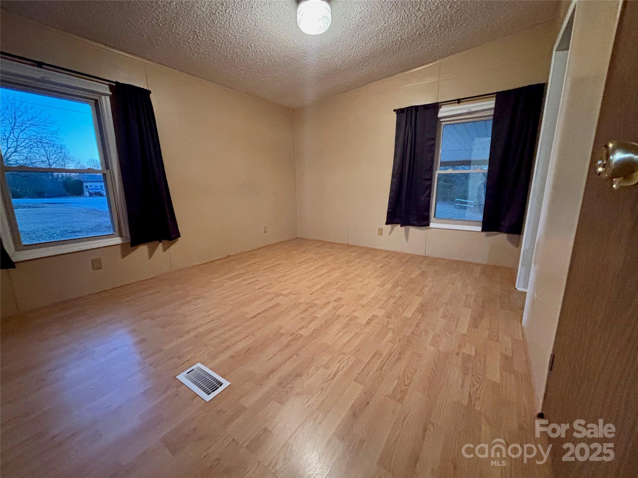 298 West B Phindeck Road Bostic, NC 28018 - Photo 29 of 34 an empty room with wooden floor and windows