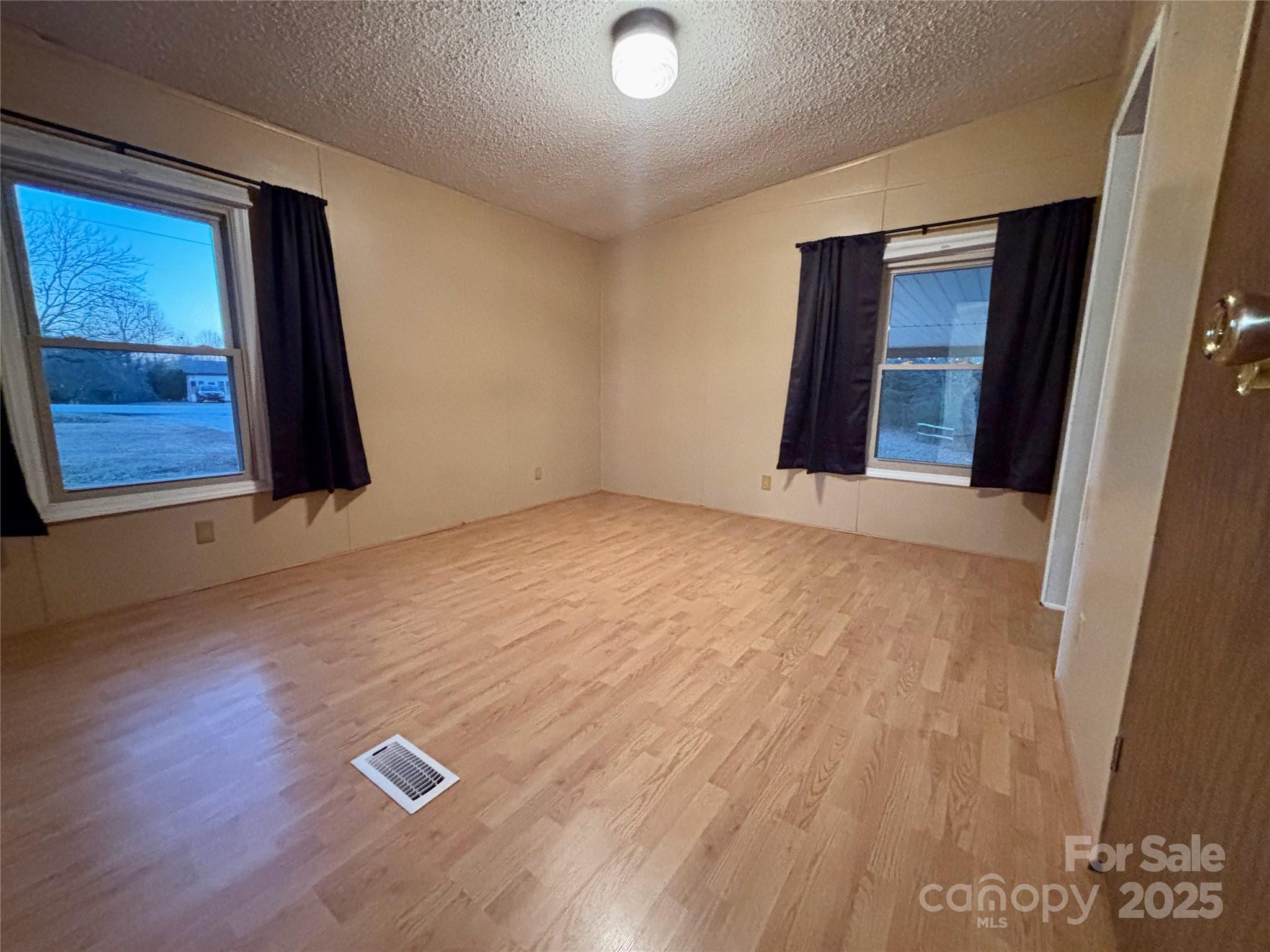 298 West B Phindeck Road Bostic, NC 28018 - Photo 30 of 34 an empty room with wooden floor and windows