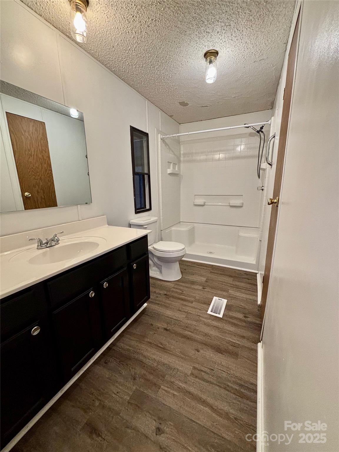 298 West B Phindeck Road Bostic, NC 28018 - Photo 31 of 34 a spacious bathroom with a double vanity sink a mirror and a toilet