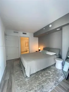 a view of a room with wooden floor and cabinet