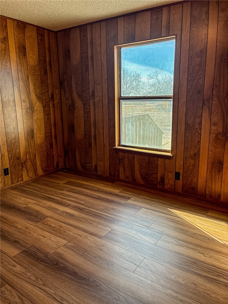 180 Recreation Road 8 Calliham, TX 78007 - Photo 12 of 17 an empty room with wooden floor and windows