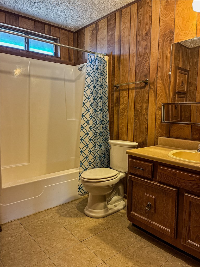 180 Recreation Road 8 Calliham, TX 78007 - Photo 13 of 17 a bathroom with a toilet and a shower curtain