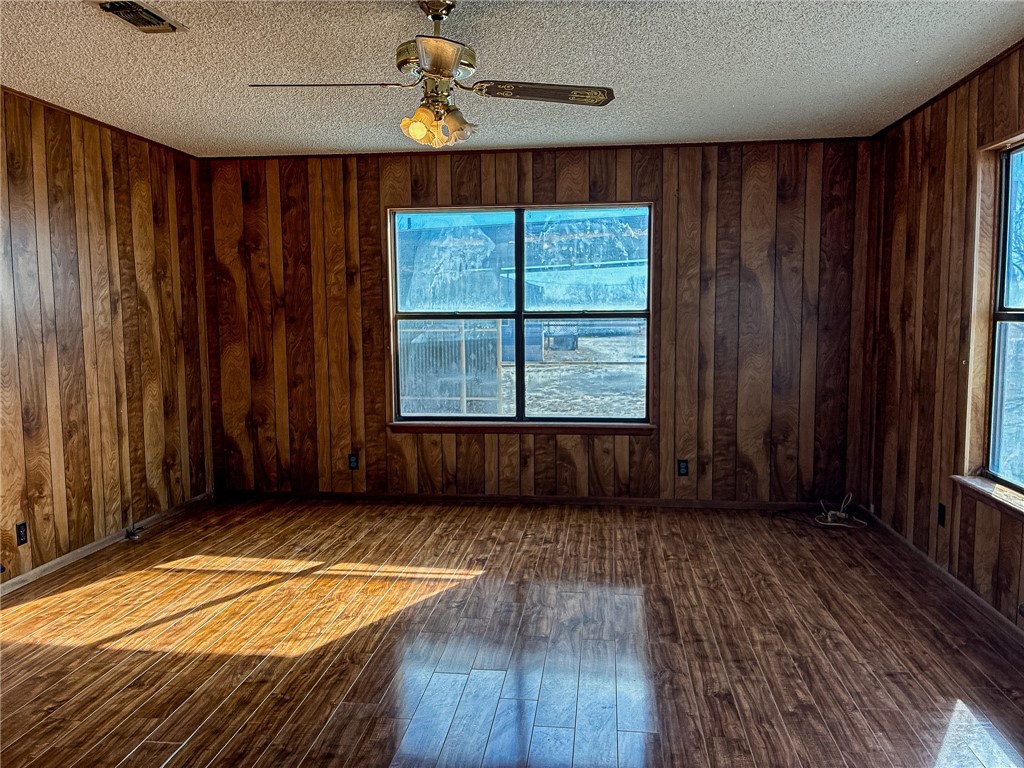 180 Recreation Road 8 Calliham, TX 78007 - Photo 5 of 17 an empty room with wooden floor fan and windows