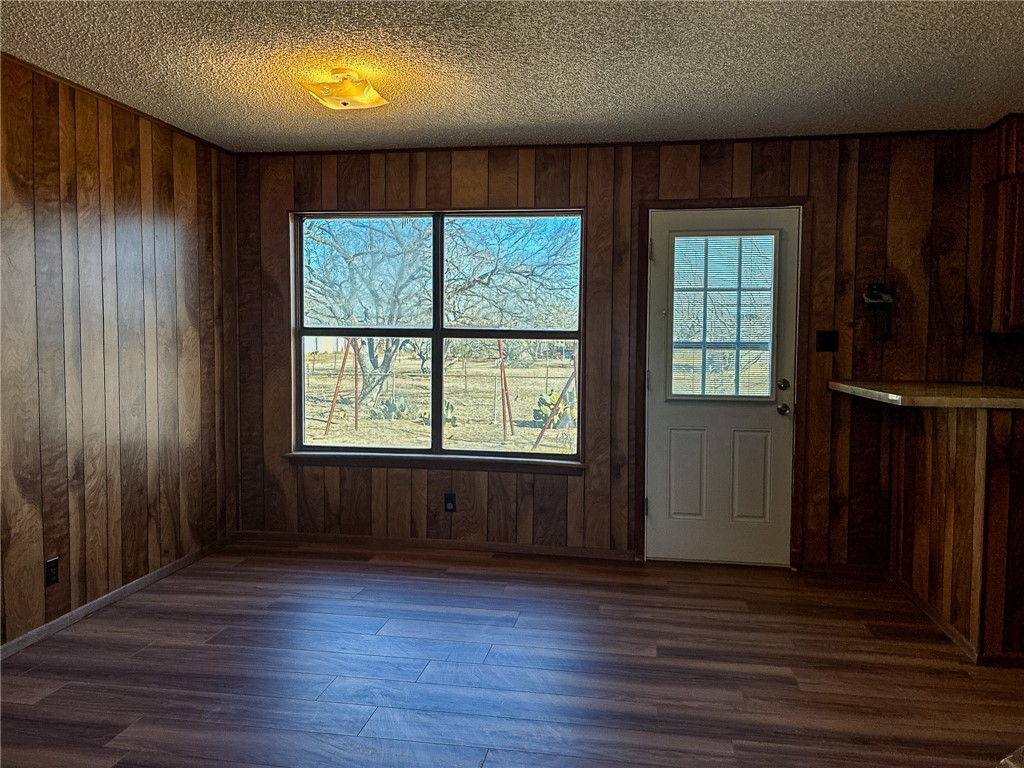 180 Recreation Road 8 Calliham, TX 78007 - Photo 7 of 17 an empty room with wooden floor and windows