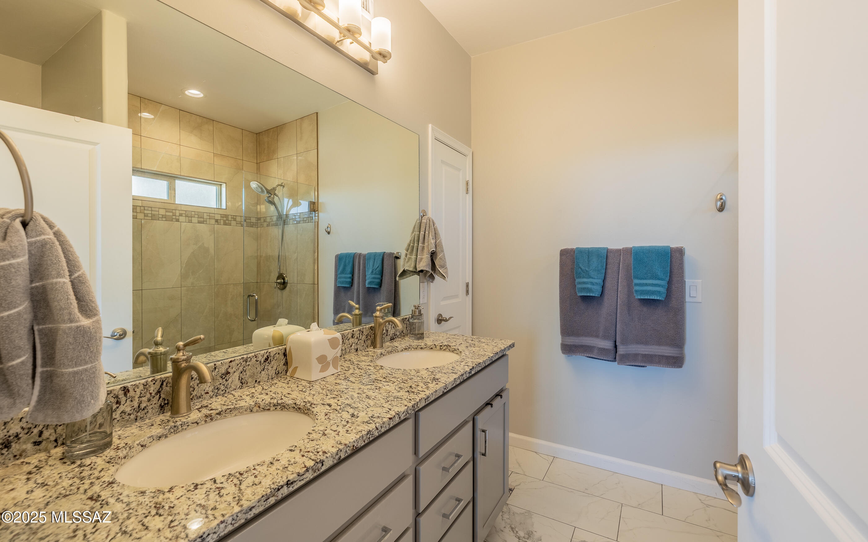 12123 Creosote Valley Road Vail, AZ 85641 - Photo 21 of 46 a bathroom with a granite countertop sink and a mirror