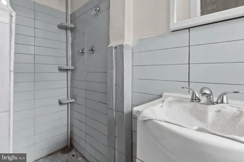 a bathroom with a sink and shower